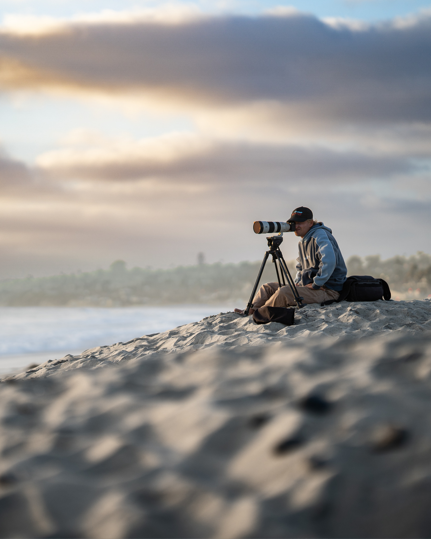 Photographer on a beach with a telephoto lens